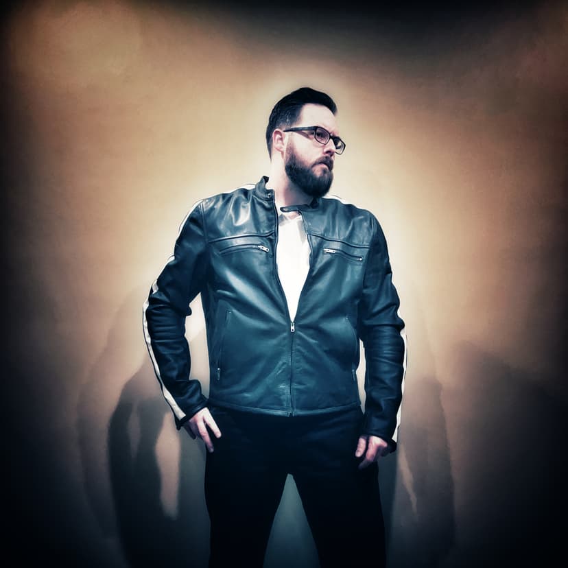 Sean Anthony Sullivan stands in leather jacket.