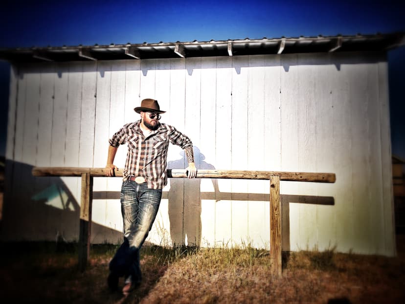 Sean Anthony Sullivan stands in front of barn.